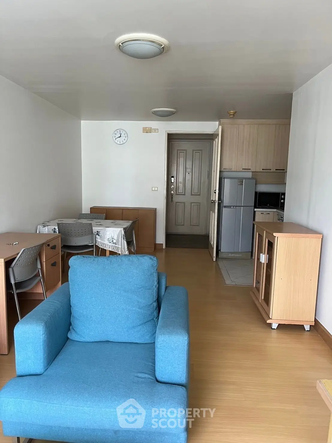 Cozy living room with modern furniture and open kitchen layout in a stylish apartment.