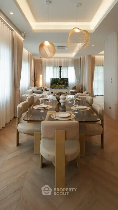 Luxurious modern living room with elegant dining area and stylish lighting fixtures.