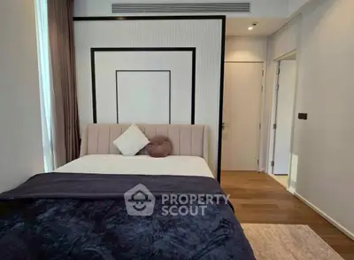 Modern bedroom with stylish decor and cozy bedding in contemporary apartment.