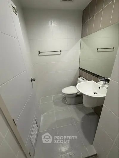 Modern bathroom with sleek fixtures and neutral tiles, perfect for a contemporary home.