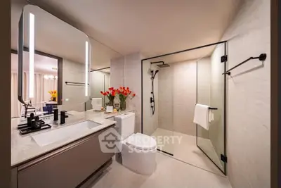 Luxurious modern bathroom with glass shower and elegant decor
