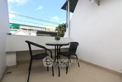 Charming small balcony with seating, perfect for relaxing outdoors.