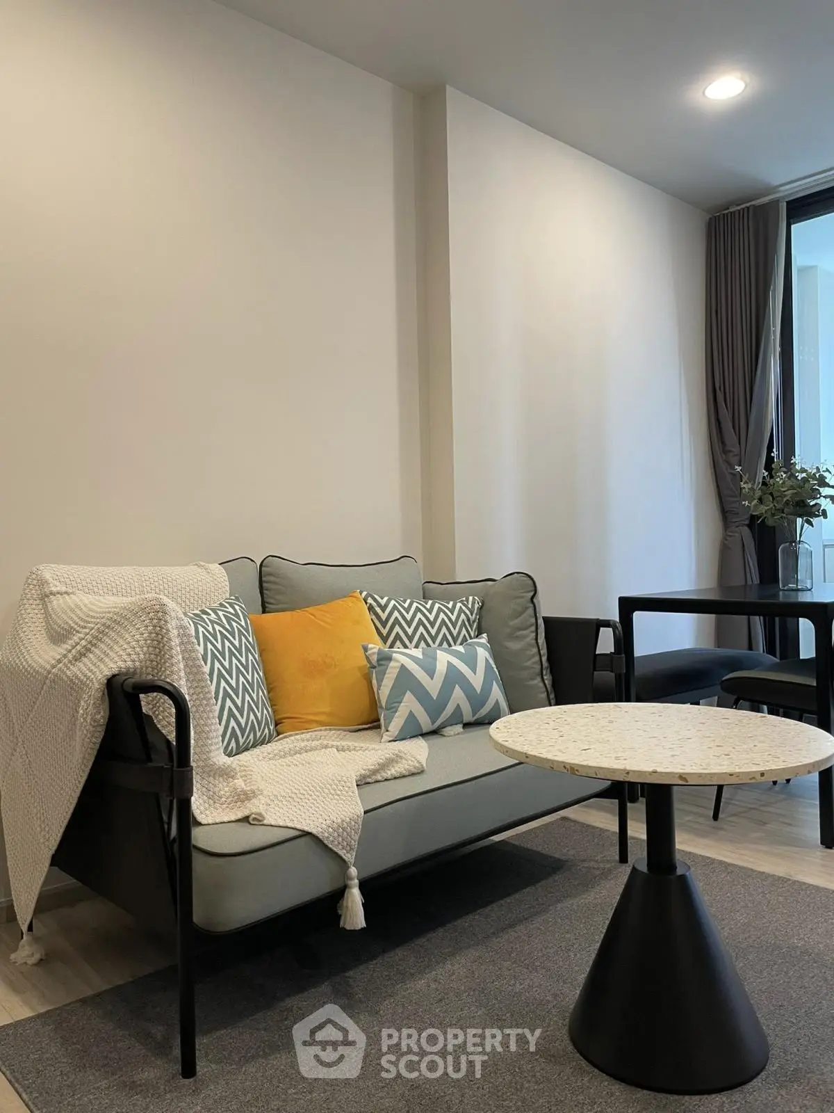 Modern living room with stylish sofa and chic decor in a cozy apartment setting.