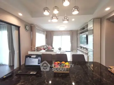 Spacious modern living room with elegant lighting and open layout, perfect for family gatherings.