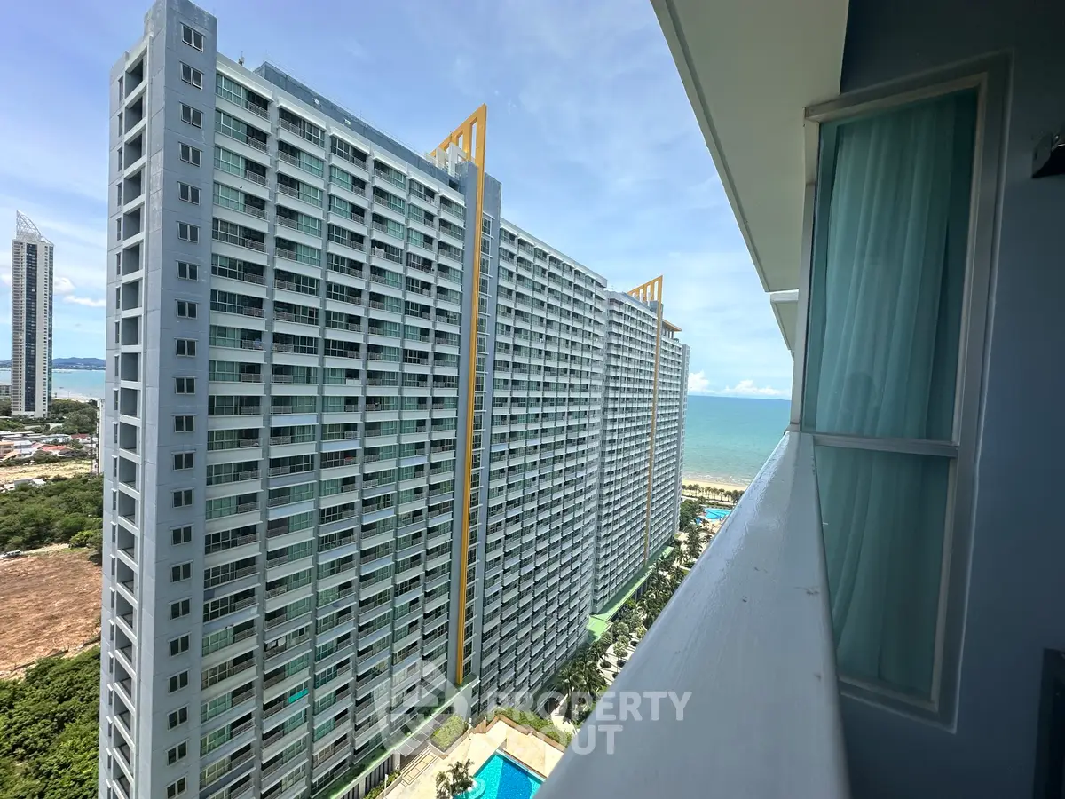 Stunning high-rise building with ocean view from balcony, perfect for luxury living.