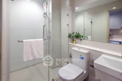 Modern bathroom with glass shower enclosure and sleek fixtures