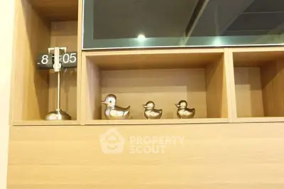 Modern wooden shelving with decorative ducks and clock, perfect for stylish living room decor.