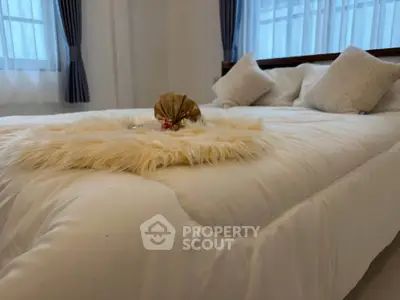 Luxurious bedroom with plush bedding and elegant decor, perfect for relaxation.