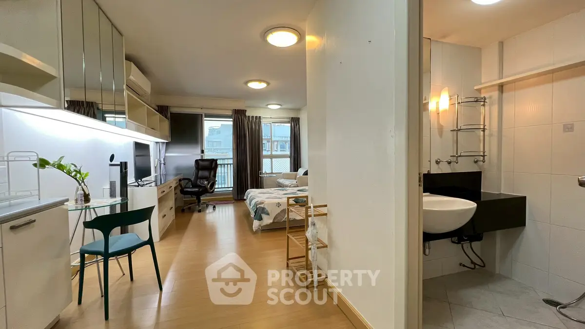 Modern studio apartment with open layout, featuring a cozy living area, compact kitchen, and stylish bathroom.