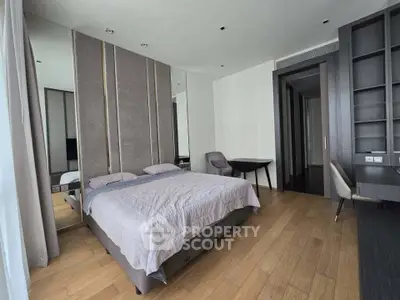 Spacious modern bedroom with elegant decor and hardwood flooring