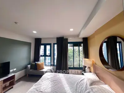 Modern bedroom with large windows and stylish decor in a high-rise apartment.
