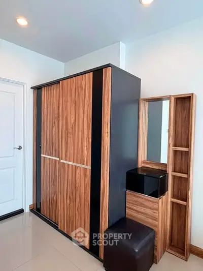Modern bedroom with sleek wooden wardrobe and matching vanity set