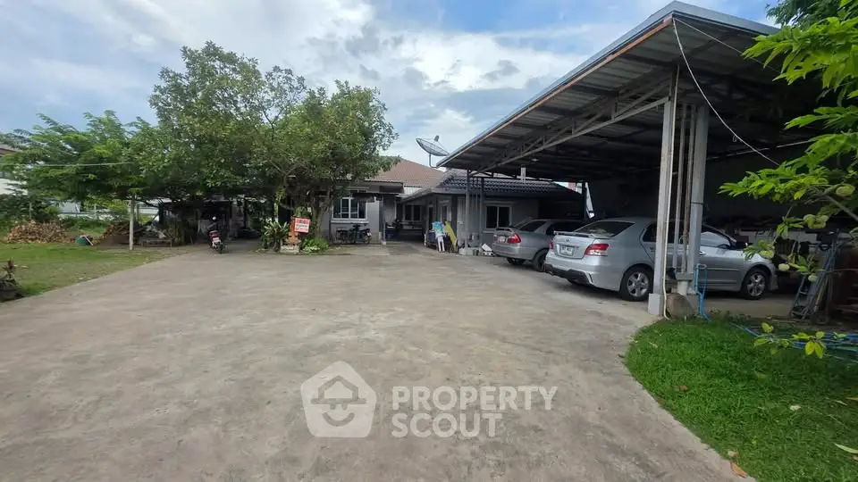 Spacious residential property with ample parking and lush greenery, perfect for family living.