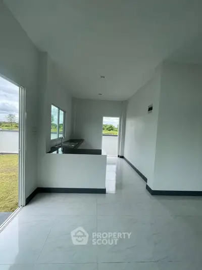 Spacious modern interior with large windows and open layout, perfect for natural light.