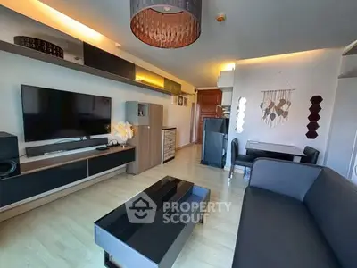 Modern living room with sleek furniture and wall-mounted TV in stylish apartment.