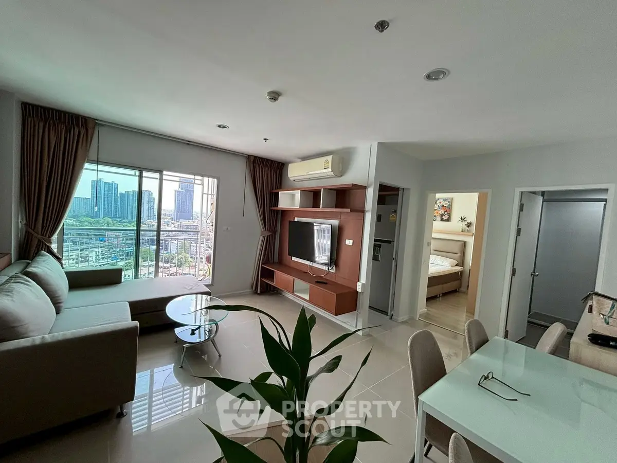 Spacious modern living room with city view, elegant furniture, and open layout in high-rise apartment.