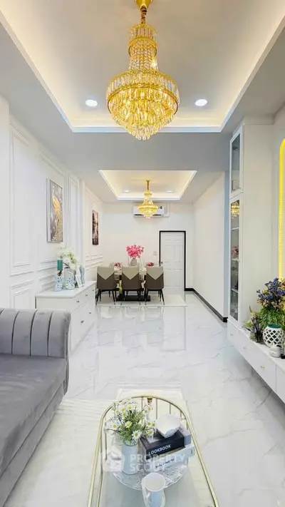 Luxurious living room with elegant chandelier and modern dining area