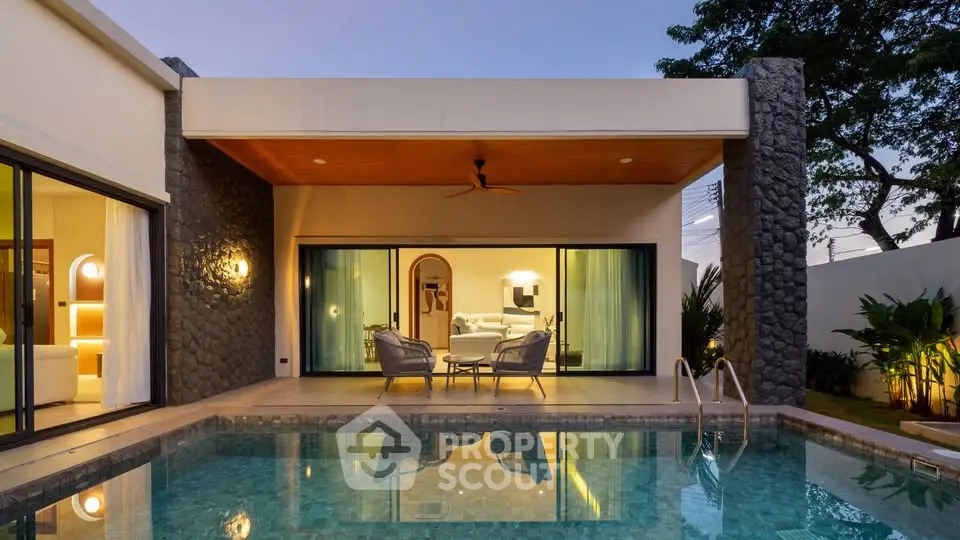 Luxurious modern villa with private pool and elegant outdoor seating area at dusk.