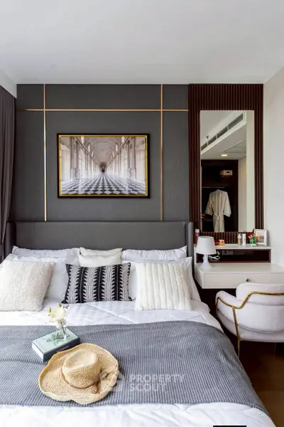 Luxurious bedroom with elegant decor and modern furnishings, featuring a stylish wall art and cozy ambiance.