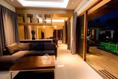 Luxurious living room with modern decor and large sliding doors opening to a stylish patio.