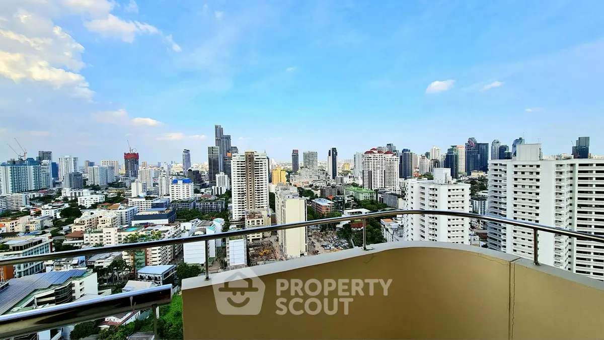 Stunning cityscape view from a high-rise balcony in a bustling urban area.