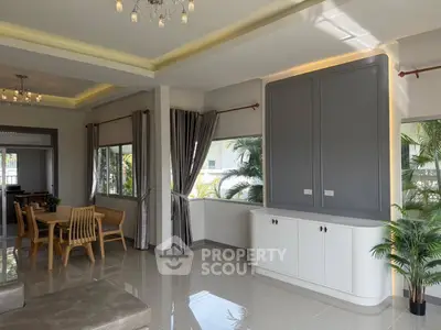 Spacious modern living room with elegant dining area and large windows