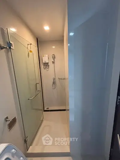 Modern bathroom with glass shower enclosure and sleek fixtures