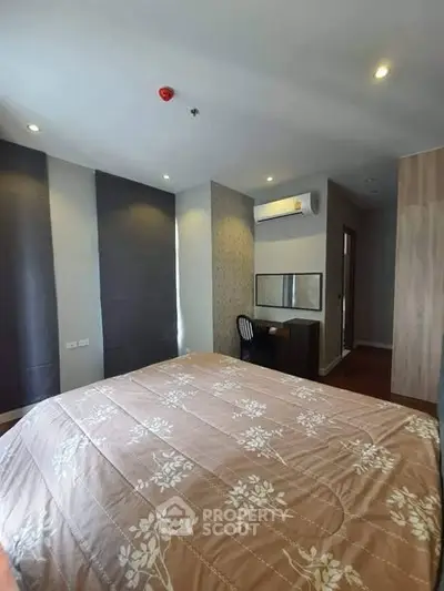 Spacious bedroom with modern decor and natural light in a stylish apartment.
