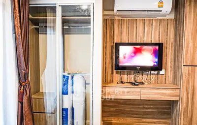 Modern bedroom with wall-mounted TV and stylish wardrobe