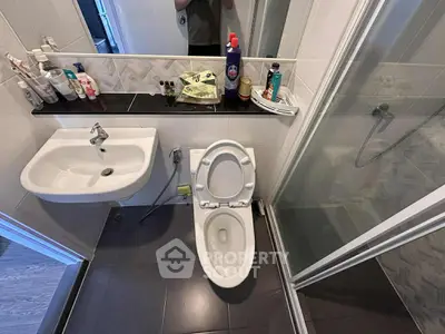 Compact bathroom with modern fixtures and shower enclosure
