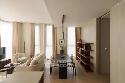 Elegant modern living room with dining area, featuring neutral tones and stylish furnishings.