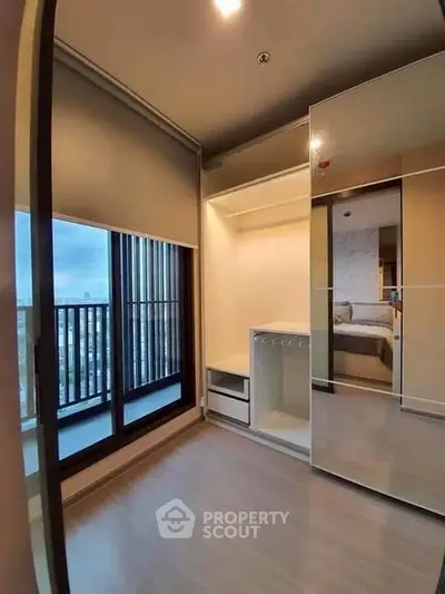 Modern bedroom with mirrored wardrobe and city view balcony