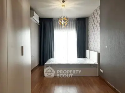 Modern bedroom with stylish lighting and large window in a contemporary apartment