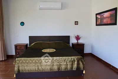 Spacious bedroom with elegant decor and air conditioning in modern home