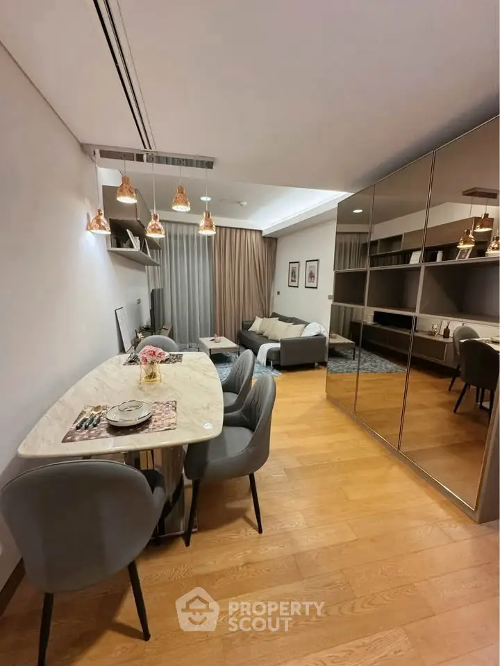 Modern living room with stylish dining area and mirrored wardrobe