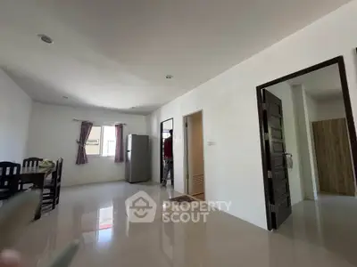 Spacious open-plan living area with dining set and modern appliances