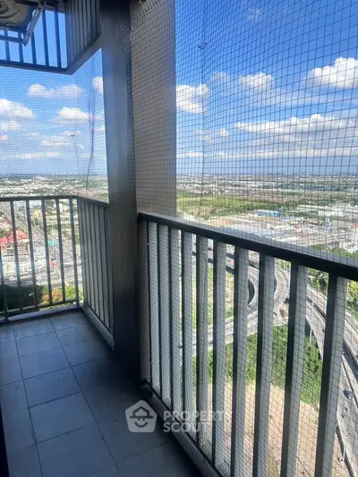 High-rise balcony with safety netting and panoramic city view