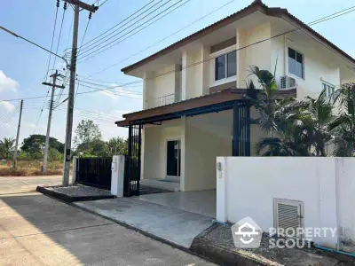 Charming two-story house with modern facade and lush greenery in a serene neighborhood.