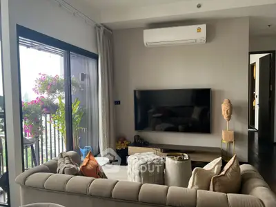 Stylish living room with modern decor and balcony view