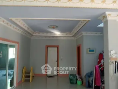 Spacious interior room with elegant ceiling design and ample natural light.