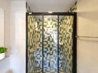 Modern bathroom with geometric tile shower and glass door