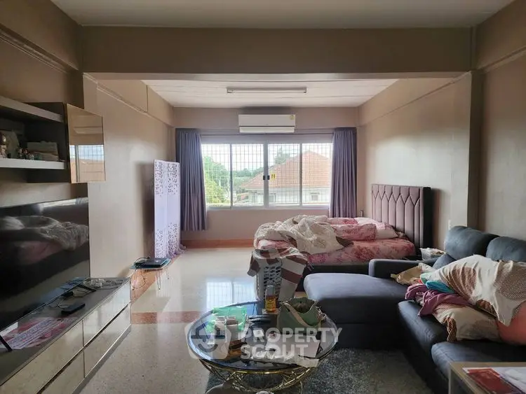 Spacious living room with modern decor and large window view