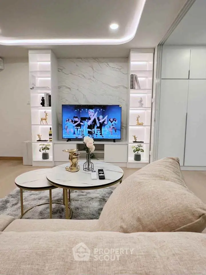 Luxurious living room with modern decor, marble accent wall, and stylish shelving units.