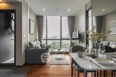 Modern living room with city view, elegant decor, and dining area in a high-rise apartment.