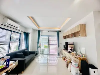Modern living room with sleek design, large windows, and stylish furniture in a bright, airy space.