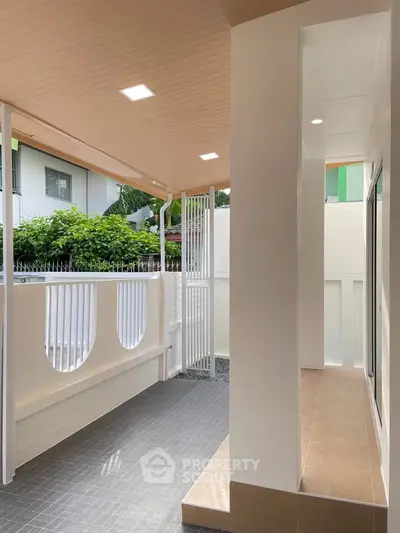 Modern covered balcony with sleek design and natural light