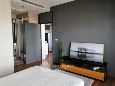 Modern bedroom with stylish decor and wooden flooring