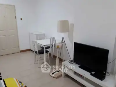 Cozy living room with modern furniture and TV setup, perfect for relaxation and entertainment.