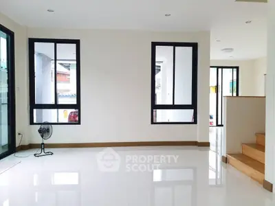 Spacious and bright living room with large windows and modern design.