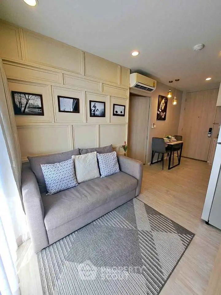Stylish living room with modern decor and cozy seating in a contemporary apartment.